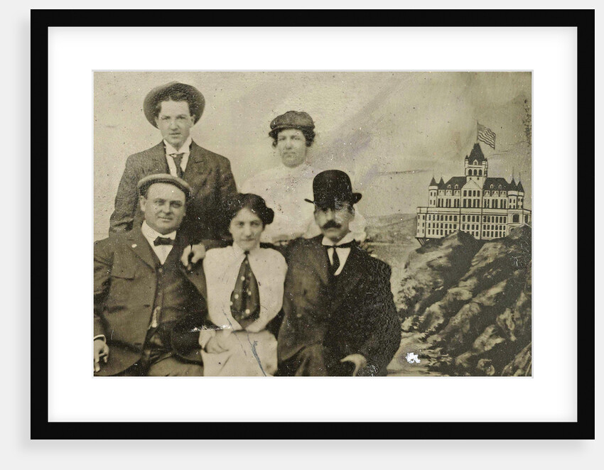 Group portrait of three men and two women in front of a painted backdrop with Cliff House in San Francisco by Anonymous