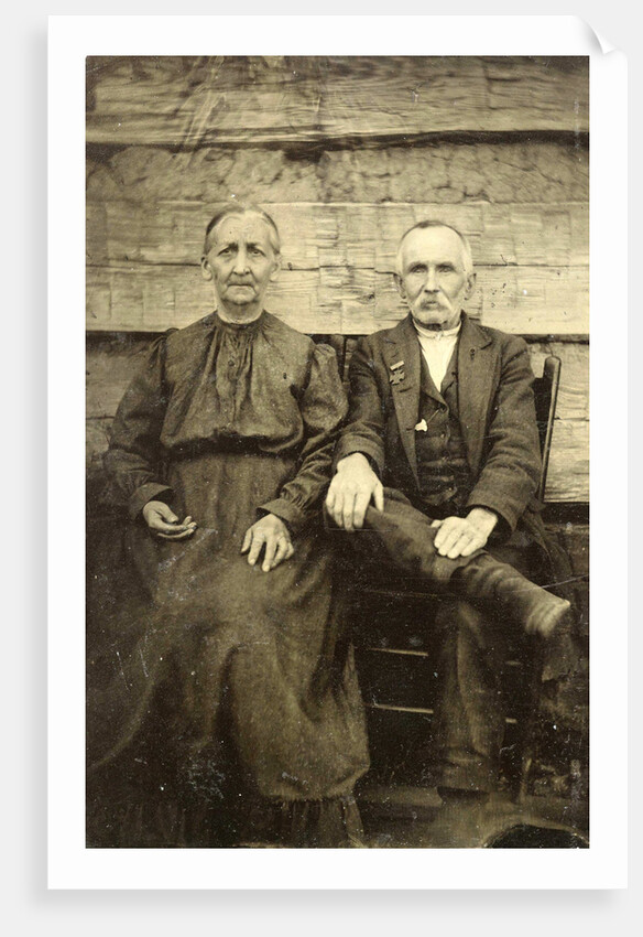 Portrait of an elderly man and woman sitting on a wooden wall or fence by Anonymous