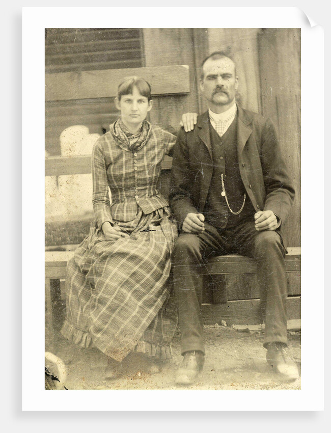 Portrait of a man and a woman sitting on a bench in front of their house (?) by Anonymous