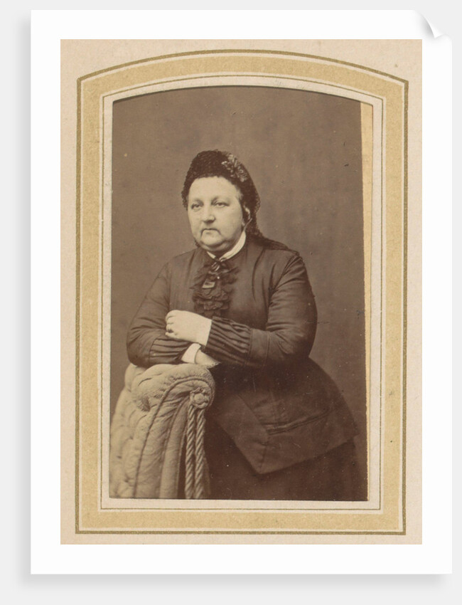 Portrait of a woman with a hat leaning on an armchair by Johannes H. Kramer