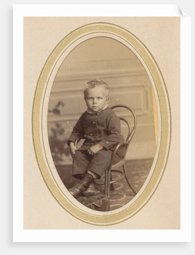 Portrait of a child on a chair with lace-up boots and a packet by J.C. Reesinck