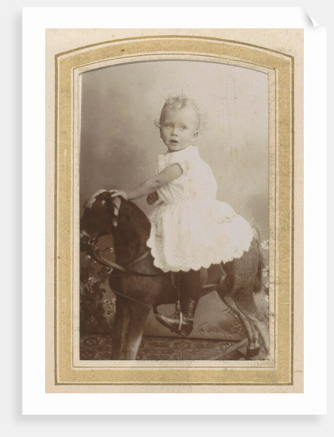 Portrait of a toddler in a dress on a rocking horse by C.J.L. Vermeulen