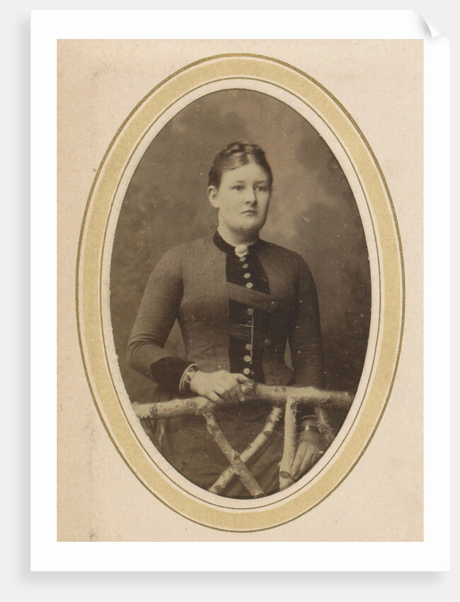 Portrait of a woman with upswept hair, a jacket with buttons and an ornament by J.H. van der Laag