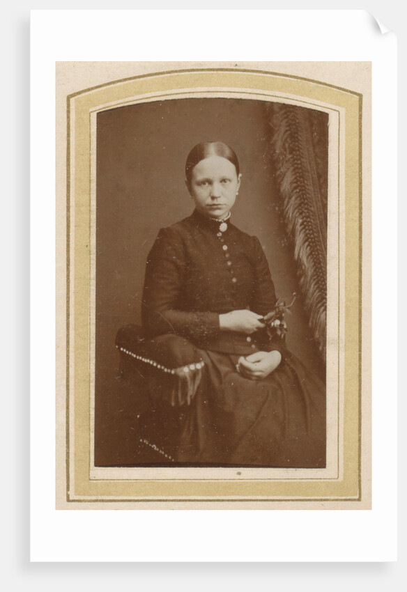 Portrait of a seated woman in a long dress with a twig in hand by H. Bulens Jr