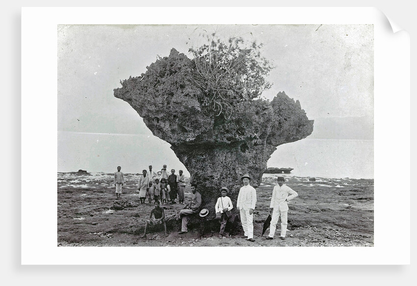 Group of people at rock formation Stone Hat (Batu Tjepeh) in Ambon, Indonesia by Anonymous