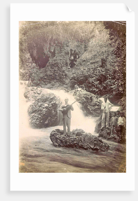 Guitar playing man at a waterfall at Batu Gantong in Ambon, Indonesia by Anonymous