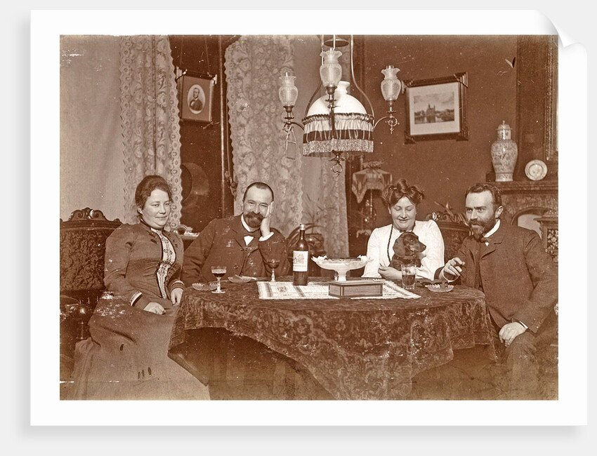 Two men and two women sitting around a table with glasses of wine by Anonymous