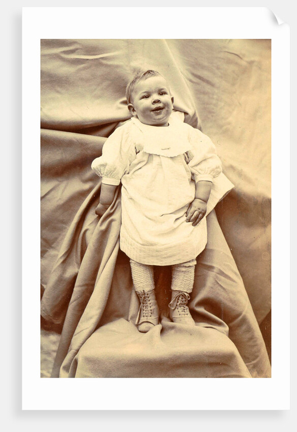 Portrait of a young child in a shirt with lace-up boots by Anonymous
