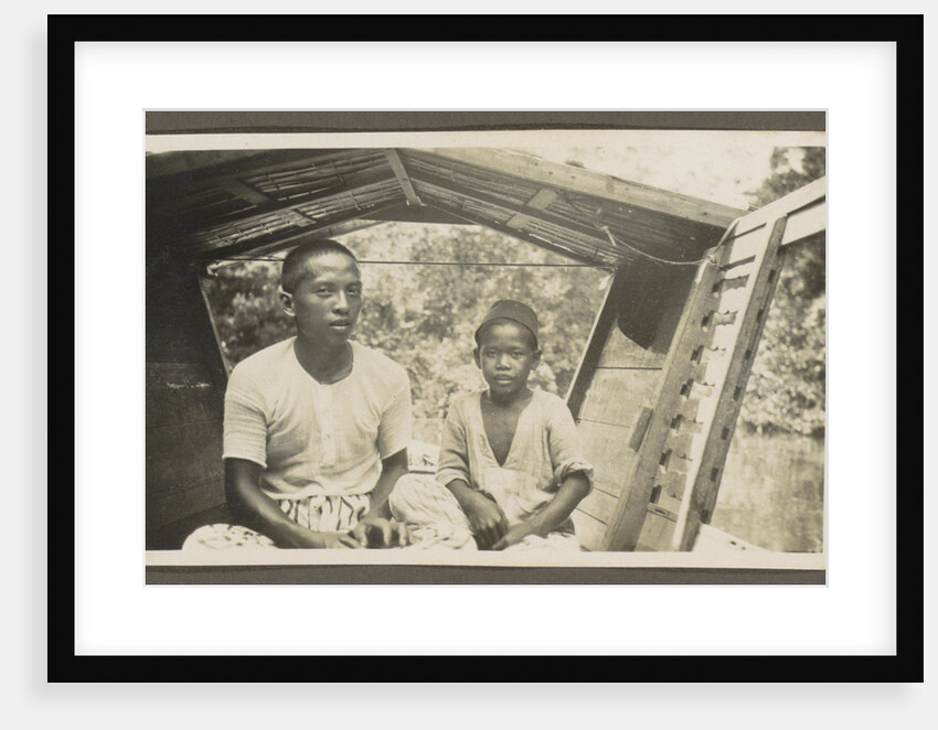 Two Indian boys sitting in roofed wooden boat by Anonymous