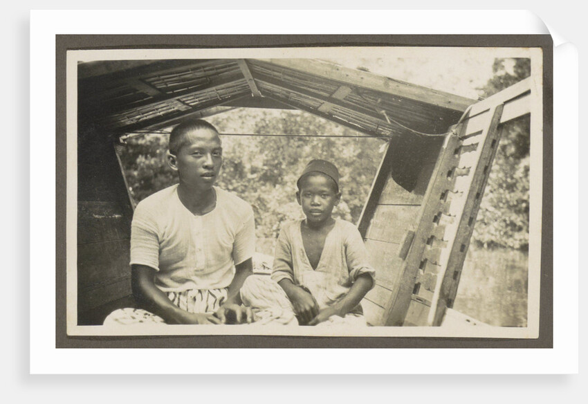 Two Indian boys sitting in roofed wooden boat by Anonymous