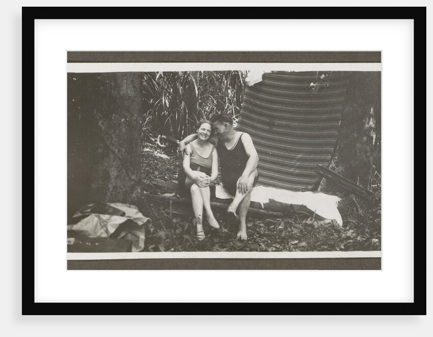 Man and a woman in swimwear on a bench in a forest by Anonymous