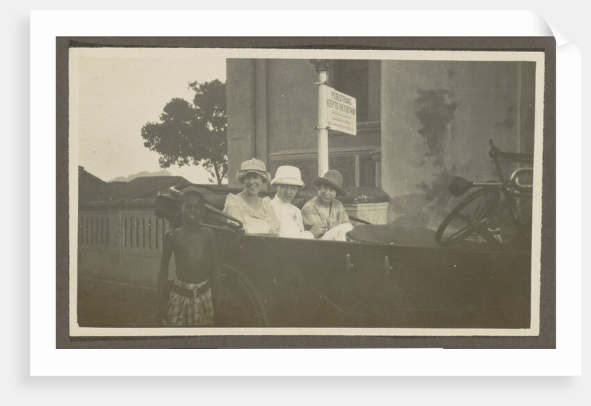 Triad sitting in the backseat of a car, leading a boy by Anonymous