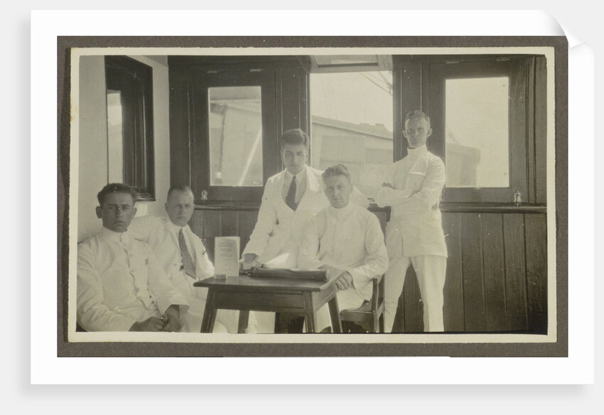 Five men in tropical attire sitting around a table by Anonymous
