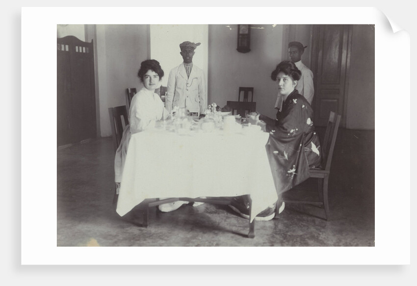 Group portrait of young women at the table with servants in the Dutch East Indies, indonesia by Anonymous