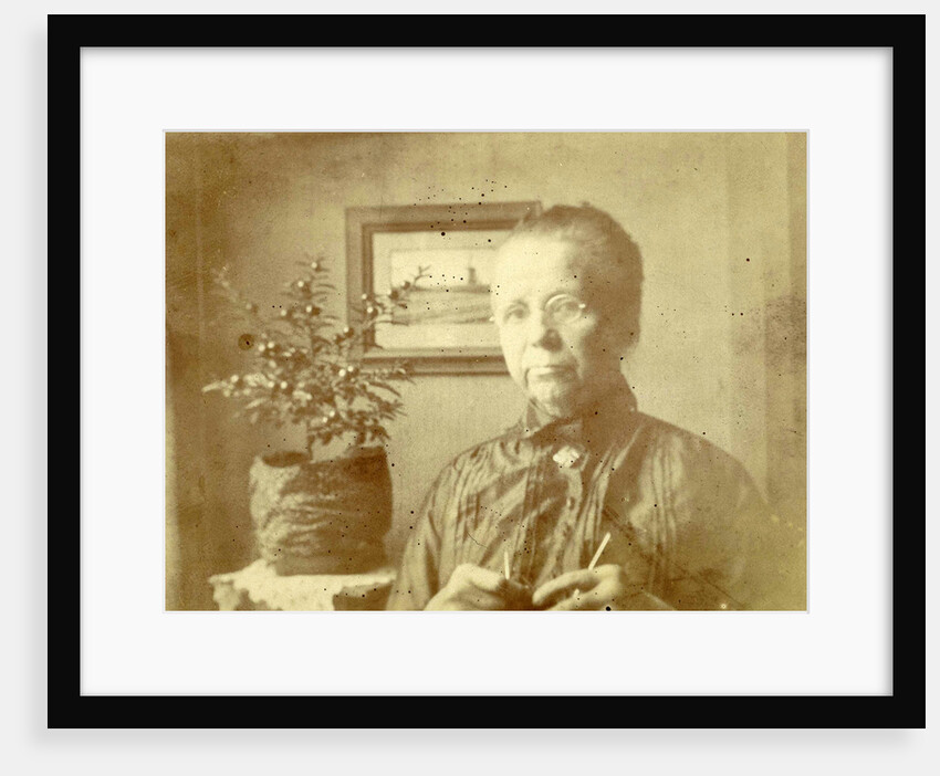Portrait of an old lady with glasses in a living room by Anonymous