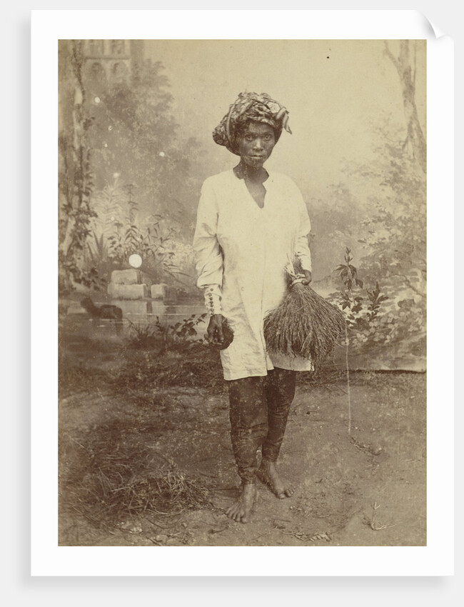 Studio Portrait of woman with paddy in her hand by Anonymous