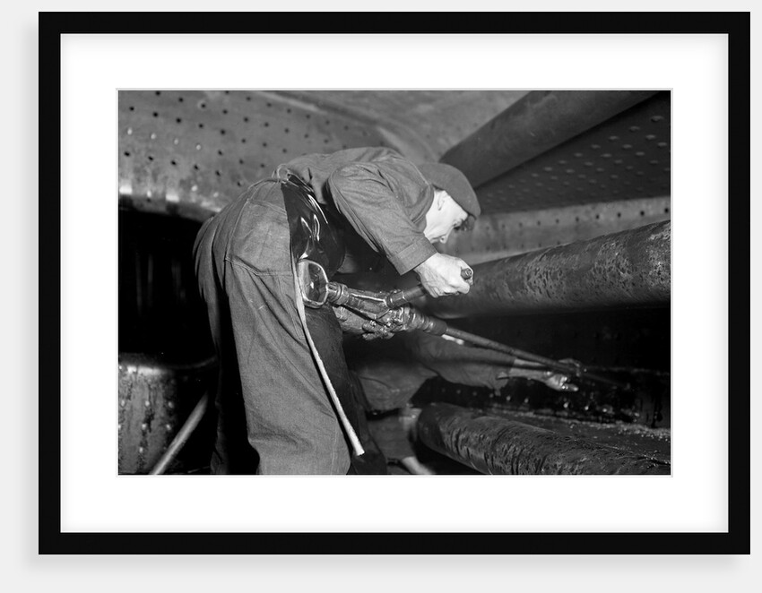 Eddystone, Pennsylvania - Railroad parts. Boilermaker tapping for stay-bolts in boiler of a modern locomotive, March 1937 by Lewis Hine