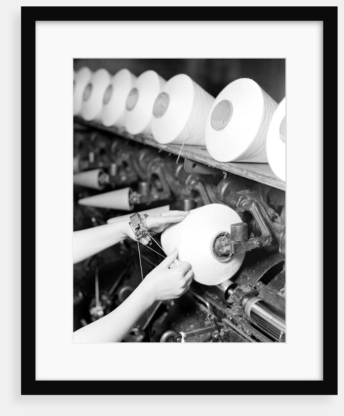 High Point, North Carolina - Textiles. Pickett Yarn Mill. Winder operator by Lewis Hine