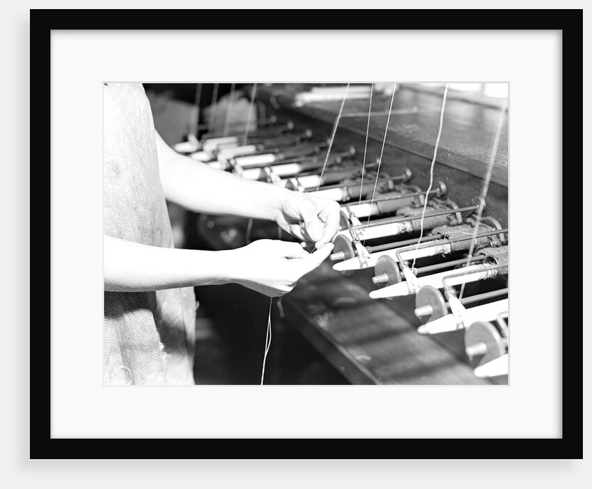 Paterson, New Jersey - Textiles. Quiller tying the broken ends of thread being wound on to quills, March 1937 by Lewis Hine