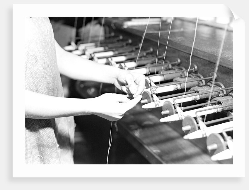 Paterson, New Jersey - Textiles. Quiller tying the broken ends of thread being wound on to quills, March 1937 by Lewis Hine