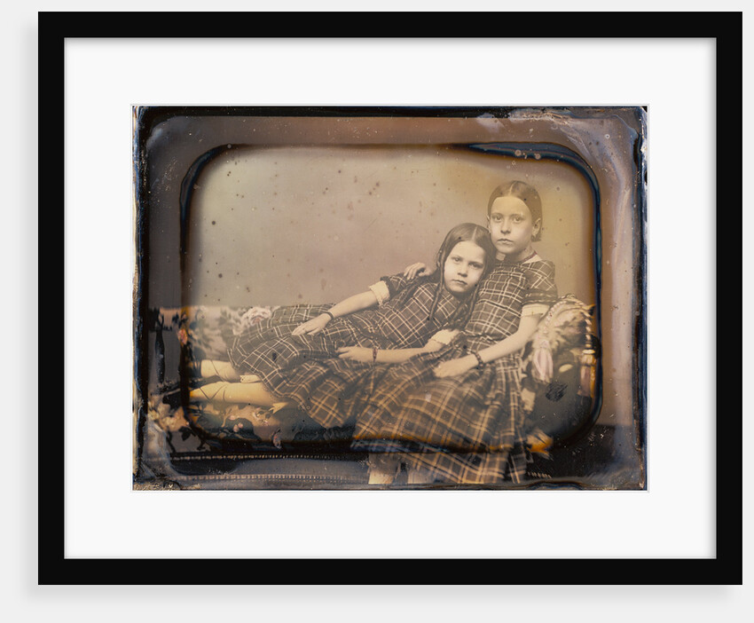 Portrait of two girls reclining on chaise lounge by Sheldon K. Nichols