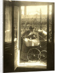 Unidentified woman standing near a pram on a balcony of the house Friedrichstrasse Berlin, Germany by Waldemar Titzenthaler