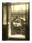 Unidentified woman standing near a pram on a balcony of the house Friedrichstrasse Berlin, Germany by Waldemar Titzenthaler