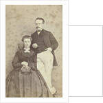 A seated woman with a book in her hands, leaning on her chair, a man in white trousers, one hand in his pocket by F.D. van Rosmalen & Zoon