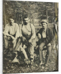 Portrait of three men sitting on a tree stump? In a forest by Anonymous