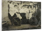 Group portrait of ten women and a man huddled in a carriage in a studio by Anonymous