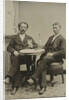 Portrait of two men sitting at the table in a studio, with a bottle and a glass, an imitation salon decor by Anonymous