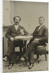 Portrait of two men sitting at the table in a studio, with a bottle and a glass, an imitation salon decor by Anonymous