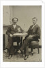 Portrait of two men sitting at the table in a studio, with a bottle and a glass, an imitation salon decor by Anonymous