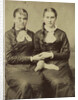 Portrait of two women sitting next to each other and holding each other's hand by Anonymous