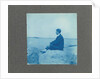 Man in profile, sitting on a rock by the sea, United States, Cyanotype, a photographic printing process that produces a cyan-blue print by Anonymous