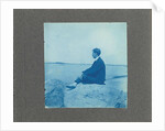 Man in profile, sitting on a rock by the sea, United States, Cyanotype, a photographic printing process that produces a cyan-blue print by Anonymous