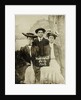 Portrait of a man and two women in front of a painted backdrop (tree, lake and mountains) and a sign that read 'Huntington FAIR 1905 by Anonymous