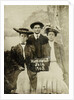 Portrait of a man and two women in front of a painted backdrop (tree, lake and mountains) and a sign that read 'Huntington FAIR 1905 by Anonymous