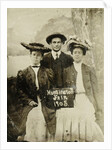 Portrait of a man and two women in front of a painted backdrop (tree, lake and mountains) and a sign that read 'Huntington FAIR 1905 by Anonymous