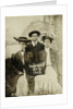 Portrait of a man and two women in front of a painted backdrop (tree, lake and mountains) and a sign that read 'Huntington FAIR 1905 by Anonymous