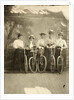 Group portrait of five women with bikes for a painted backdrop with forest by Anonymous