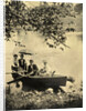 Two men and two women in a rowboat on a lake by Anonymous