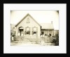 View of a wooden house with about nine people before or standing in doorways, United States by Anonymous