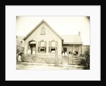 View of a wooden house with about nine people before or standing in doorways, United States by Anonymous
