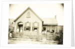 View of a wooden house with about nine people before or standing in doorways, United States by Anonymous