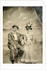 Portrait of a man and woman sitting in front of a painted backdrop (beach, sea and pier) by Anonymous