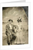 Portrait of a man and woman sitting in front of a painted backdrop (beach, sea and pier) by Anonymous