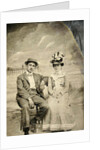 Portrait of a man and woman sitting in front of a painted backdrop (beach, sea and pier) by Anonymous