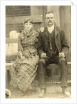 Portrait of a man and a woman sitting on a bench in front of their house (?) by Anonymous