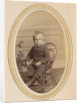 Portrait of a child on a chair with lace-up boots and a packet by J.C. Reesinck